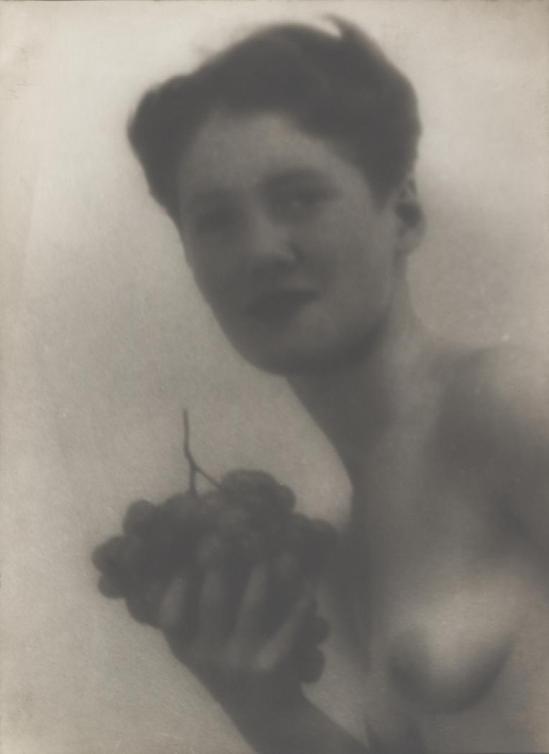 Josef Breitenbach-soft-focus bust of nude woman holding grapes, Paris, . 1933
