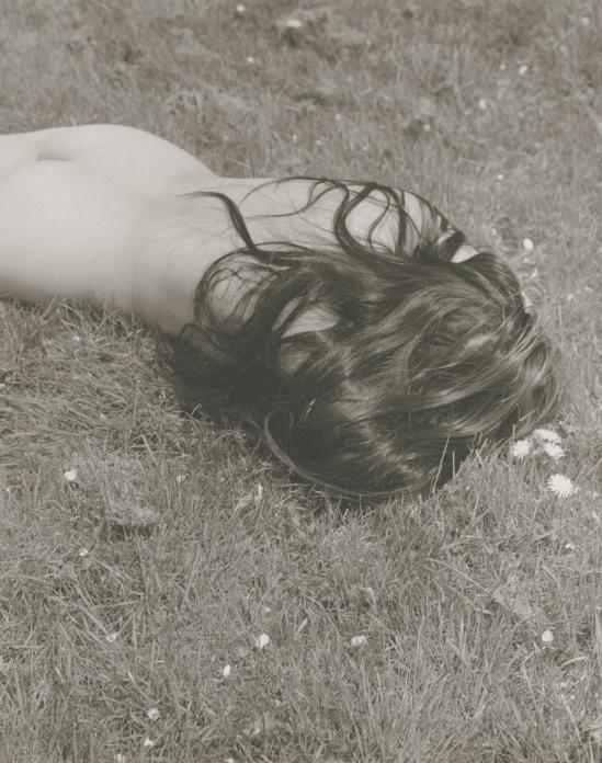 Josef Breitenbach-untitled ,female nude with long dark hair lying face-down on grass , USA  1961