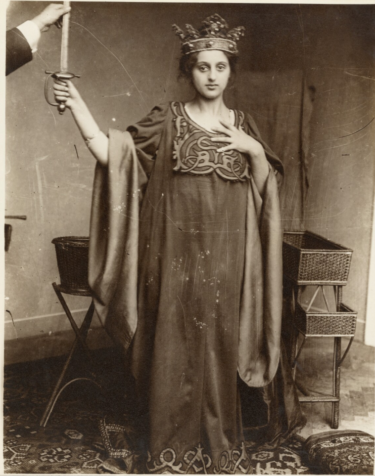 Alphonse Maria Mucha - female moel wearing crow and holding sword, negative 1900s; print about 1980