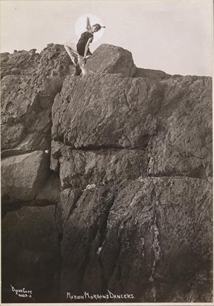 Byron Company - one of the Marion Morgan's Dancers posing on the rock, Rye, New York. , 1920