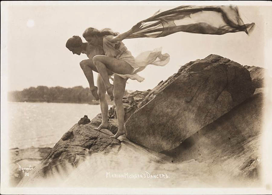 Byron Company - Two of Marion Morgan's dancers with flowing scarf, posing on rocks at the beach Rye, New York. 1920