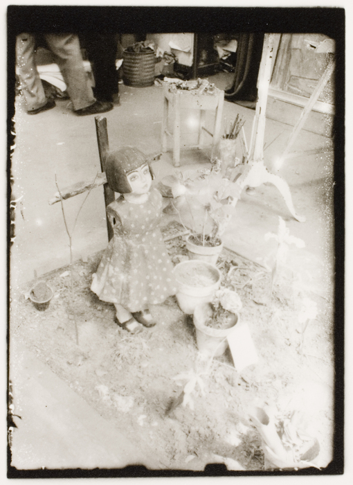 Fred Stein-Armless doll standing in doll garden, 1935